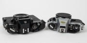 NIPPON KOGAKU: Two c. 1970s camera bodies - one black Nikon EL with black AW-1 Auto Winder attachment and body cap, and one chrome Nikon FG-20 with body cap. (2 camera bodies) - 2