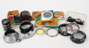 WALZ: An accumulation of nineteen photography accessories, many of them in maker's boxes or plastic cases, comprising eleven lens filters, four lens hoods, one self-timer, one telescopic viewfinder, one rangefinder, and one Parwalzer Close-Up Set. (19 items)