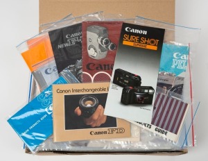 CANON: One A4 archive box containing eighty Canon product brochures, sales guides, and instruction booklets, each sealed in a plastic sleeve. (80 items)