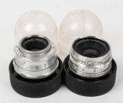 STAEBLE: Two c. 1950s lenses for Braun cameras, with rear caps and clear plastic containers - one Staeble-Lineogon 35mm f3.5 [#739325] and one Staeble-Telexon E 85mm f5.6 [#667636]. (2 items) - 2