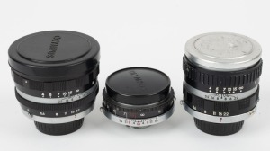 OLYMPUS: Three lenses in black and chrome with bayonet mounts for Olympus Ace series rangefinder cameras - one E. Zuiko-T 80mm f4 [#101130] with front and rear caps, one E. Zuiko-T 80mm f5.6 [#304017] with front and rear caps, and one E. Zuiko-W 35mm f2.8