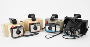 POLAROID: Four instant film cameras with wrist straps - one Swinger II Land Camera, one Colorpack II Land Camera, and two Swinger Model 20 Land Cameras. (4 cameras)