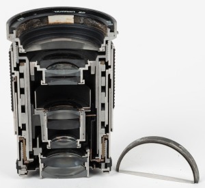 TAMRON: Half cutaway model Tamron SP 28-135mm f4-4.5 lens, presented by Tamron representatives during their viewing of the Michael's Camera Museum in June 1993.