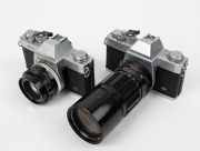 OLYMPUS: Two c. 1971 chrome-body Olympus FTL SLR cameras - one [#142373] with E. Zuiko Auto-T 200mm f4 lens [#101558], and one [#147213] with F. Zuiko Auto-S 50mm f1.8 lens [#127172]. (2 cameras) - 2