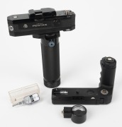 ASAHI KOGAKU: Four Pentax camera accessories - one c. 1975 Pentax KX Motor Drive and Battery Grip [#1022290], one c. 1975 KX Voltmeter, one c. 1980 Pentax Winder ME II [#2095140], and one Pentax Self-Timer in maker's plastic case.&nbsp;(4 items)