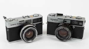 OLYMPUS: Two early 1970s rangefinder cameras - one Olympus-35 SP [#120246] with G. Zuiko 42mm f1.7 lens, and one Olympus-35 SPn [#392445], also with G. Zuiko 42mm f1.7 lens. (2 cameras)