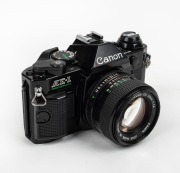 CANON: Circa 1981 black-body Canon AE-1 Program SLR camera [#3673886], with FD 50mm f1.4 lens [#6726548].