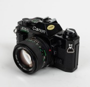 CANON: Circa 1981 black-body Canon AE-1 Program SLR camera [#3673886], with FD 50mm f1.4 lens [#6726548]. - 2