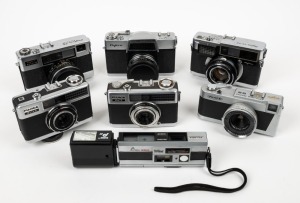 FUJIFILM: Seven c. 1960s Fujica cameras - one Fujica Half, one Fujica Drive, one Fujica 35-EE, one Fujica 35 Auto-M, one Fujicarex II, one Fujica Rapid S2, and one Pocket Fujica 350 Wide. (7 cameras)