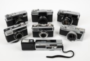 FUJIFILM: Seven c. 1960s Fujica cameras - one Fujica Half, one Fujica Drive, one Fujica 35-EE, one Fujica 35 Auto-M, one Fujicarex II, one Fujica Rapid S2, and one Pocket Fujica 350 Wide. (7 cameras)