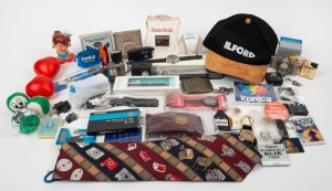 VARIOUS MANUFACTURERS: An accumulation of ninety-one promotional items, including multiple wristwatches, pens, calculators, balls, cigarette lighters, pin badges, tie clips, cufflinks, keyrings, etc., featuring the branding of such manufacturers as Yashica, Fujifilm, Polaroid, Angénieux, Tamron, Petri, Konica, Samsung, Casio, Agfa, Argus, and many others. (91 items)