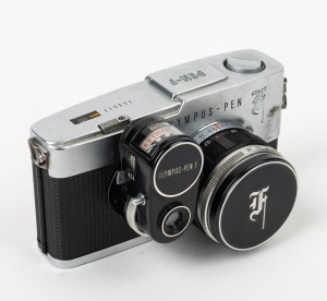 OLYMPUS: Pen F SLR camera [#159517], c. 1963, with F. Zuiko Auto-S 38mm f1.8 lens [#170815], ASA exposure meter attachment, and metal front lens cap. The world's first 35mm half-frame SLR.