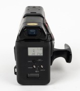 YASHICA: Circa 1988 Samurai x3.0 half-frame SLR camera [#285192] with Yashica Zoom 25-75mm f3.5-4.3 lens, lens cap, and hand grip attachment. - 3
