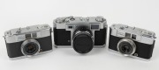 YASHICA: Three c. 1960 35mm cameras - one Yashica 35 [#38122080] with Yashinon 45mm f2.8 lens [#70807] and front lens cap, and two Yashica Mimy models [#ME4051540 & #ME3081166], one in black and one in grey,&nbsp;with Yashinon 28mm f2.8 lenses and differing bo