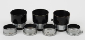 LEITZ: Seven lens hoods for Elmar 50mm - four chrome FISON models with differing engraving details, together with three FIKUS adjustable hoods in black and chrome. (7 items)