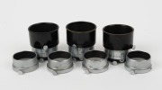 LEITZ: Seven lens hoods for Elmar 50mm - four chrome FISON models with differing engraving details, together with three FIKUS adjustable hoods in black and chrome. (7 items) - 2