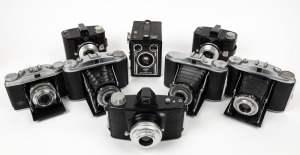AGFA: Eight c. 1950s cameras - one Isolette II with Apotar lens, one Isolette II with Agnar lens, one Isolette V with Agnar lens, one Solinette II with Solinar lens, two Clack box cameras with differing typographic details, one made-in-Germany Click-I, and one plastic Synchro-Box with Art Deco faceplate. (8 cameras)