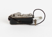 LEITZ: Extremely rare 23x13x14mm stanhope&nbsp;microphotograph viewer in shape of Leica camera, featuring photograph of the Leitz factory in Wetzlar. These were pinned as souvenirs to the lapels of visitors to the Leitz exhibit at the first camera Photokina&nbsp;tr - 2