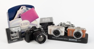 OLYMPUS: Twelve promotional items - two Olympus Pen dummy digital cameras, two Olympus OM-D dummy digital cameras, four black and two silver Olympus OM-1 miniatures sealed in retail packaging, one Olympus Mju camera stand, and one Olympus Mju point-of-sal