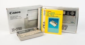 CANON: Circa 1983 Canon X-07 Handheld Computer [#216029] in maker's box with case and reference manuals, together with one Canon X-710 Color Graphic Printer in maker's box with case, power, and data cables. (2 items)