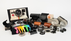 POLAROID: An accumulation of thirty-three photographic accessories and promotional items, including a complete 591 Portrait Attachment Kit, two 540 Close-Up Lens Kits, two 516 Cloud Filter kits, two Wink-Lights, 128 Development Timer, 192 Self-Timer, thre