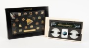 OLYMPUS: Commemorative '10 Million Sold'&nbsp;framed sales retrospective set of twenty-one pins depicting many famous camera models and gold plaque thanking Michaels Camera Video & Digital, together with black protective sleeve.&nbsp;Also one 90th Anniversary Olymp