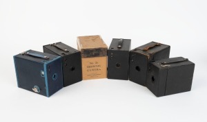 KODAK: Five c. 1920s box cameras - one black No. 2A Model B Brownie, one blue No. 2A Model C Brownie, one black coarse-grained No. 2A Model C Brownie in maker's box, one black fine-grained No. 2A Model C Brownie, and one black No. 2 Model B Hawk-Eye. (5 cameras)