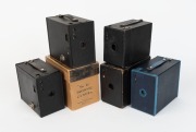 KODAK: Five c. 1920s box cameras - one black No. 2A Model B Brownie, one blue No. 2A Model C Brownie, one black coarse-grained No. 2A Model C Brownie in maker's box, one black fine-grained No. 2A Model C Brownie, and one black No. 2 Model B Hawk-Eye. (5 c - 2