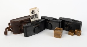 PURMA: Three c. 1937 Purma Special black Bakelite viewfinder cameras, one with lens cap, and one with lens cap, leather case, and instruction booklet, together with one lens hood in maker's box and two lens filters also in maker's boxes. (7 items)