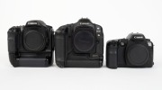 CANON: Three black digital SLR camera bodies with body caps - one c. 2002 Canon EOS-1Ds [#112850], one c. 2003 Canon EOS-10D [#396044], and one c. 2006 EOS D30 [#113400501], also known as the EOS 30D. (3 cameras) - 2