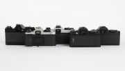 ASAHI KOGAKU: Five SLR camera bodies with metal lugs and plastic body caps - one c. 1973 black Pentax ES II [#6695677], one c. 1977 chrome Pentax K1000 SE [#8355371], one c. 1982 chrome Pentax ME F [#3586640], one c. 1985 black Pentax P30 [#4183660] with - 3