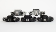 ASAHI KOGAKU: Five SLR camera bodies with metal lugs and plastic body caps - one c. 1973 black Pentax ES II [#6695677], one c. 1977 chrome Pentax K1000 SE [#8355371], one c. 1982 chrome Pentax ME F [#3586640], one c. 1985 black Pentax P30 [#4183660] with - 4