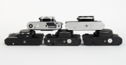ASAHI KOGAKU: Five SLR camera bodies with metal lugs and plastic body caps - one c. 1973 black Pentax ES II [#6695677], one c. 1977 chrome Pentax K1000 SE [#8355371], one c. 1982 chrome Pentax ME F [#3586640], one c. 1985 black Pentax P30 [#4183660] with - 5