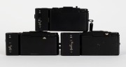 OLYMPUS: Three black-body compact cameras with attached wrist straps - one 1979 Olympus XA [#4465952] with F. Zuiko 35mm f2.8 lens and A16 flash unit, one 1979 Olympus XA-1 [#4802067] with D. Zuiko 35mm f4 lens and A11 flash unit, and one 1982 Olympus XA- - 4
