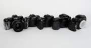 MINOLTA: Five&nbsp;black SLR camera bodies, one with lens and the others&nbsp;with plastic body caps&nbsp;- one Minolta Maxxum 7000 AF, one Minolta 7000 AF&nbsp;with AF Zoom 35-70mm f4 lens and lens hood, one additional Minolta 7000 AF, one Minolta Dynax&nbsp;7xi, and one Minolta