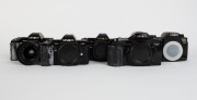 MINOLTA: Five&nbsp;black SLR camera bodies, one with lens and the others&nbsp;with plastic body caps&nbsp;- one Minolta Maxxum 7000 AF, one Minolta 7000 AF&nbsp;with AF Zoom 35-70mm f4 lens and lens hood, one additional Minolta 7000 AF, one Minolta Dynax&nbsp;7xi, and one Minolta - 2