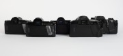 MINOLTA: Five&nbsp;black SLR camera bodies, one with lens and the others&nbsp;with plastic body caps&nbsp;- one Minolta Maxxum 7000 AF, one Minolta 7000 AF&nbsp;with AF Zoom 35-70mm f4 lens and lens hood, one additional Minolta 7000 AF, one Minolta Dynax&nbsp;7xi, and one Minolta - 3