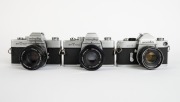 MINOLTA: Three SLR cameras - one c. 1962 Minolta SR-7 [#2393245] with Auto Rokkor-PF 53mm f2 lens [#1004720], one c. 1973 Minolta SRT-303 [#3060747] with MD Rokkor 50mm f1.7 lens [#2033565], and one c. 1975 Minolta SRT-100b [#8332984] with MC Rokkor-PF 50 - 2