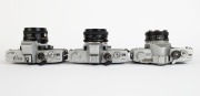 MINOLTA: Three SLR cameras - one c. 1962 Minolta SR-7 [#2393245] with Auto Rokkor-PF 53mm f2 lens [#1004720], one c. 1973 Minolta SRT-303 [#3060747] with MD Rokkor 50mm f1.7 lens [#2033565], and one c. 1975 Minolta SRT-100b [#8332984] with MC Rokkor-PF 50 - 4