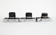 MINOLTA: Three SLR cameras - one c. 1962 Minolta SR-7 [#2393245] with Auto Rokkor-PF 53mm f2 lens [#1004720], one c. 1973 Minolta SRT-303 [#3060747] with MD Rokkor 50mm f1.7 lens [#2033565], and one c. 1975 Minolta SRT-100b [#8332984] with MC Rokkor-PF 50 - 5