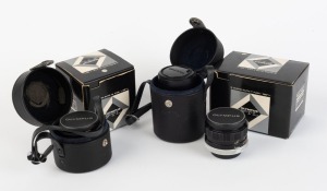 OLYMPUS: Three black and chrome lenses with Olympus FTL mounts - one G. Zuiko Auto-W 28mm f3.5 with front and rear caps together with maker's box and leather pouch, one E. Zuiko Auto-T 135mm f3.5 with front and rear caps together with maker's box and leat