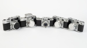 RIKEN: Five late-1950s rangefinder cameras - one Ricoh 35 [#63549] with Ricomat 45mm f3.5 lens, one type 1 Ricoh 500 [#21513] with Ricomat 45mm f2.8 lens and lens cap, one type 1 Ricoh 500 [#21065] with Ricomat 45mm f2.8 lens, lens cap, and Ricoh Meter at