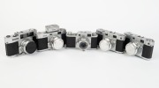 RIKEN: Five late-1950s rangefinder cameras - one Ricoh 35 [#63549] with Ricomat 45mm f3.5 lens,&nbsp;one type 1 Ricoh 500 [#21513] with Ricomat 45mm f2.8 lens and lens cap, one type 1&nbsp;Ricoh 500 [#21065] with Ricomat 45mm f2.8 lens,&nbsp;lens cap, and Ricoh Meter at
