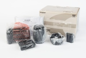 OLYMPUS: Mint-condition Olympus E-330 digital SLR camera with Zuiko Digital 14-45mm f3.5-5.6 lens. Still sealed in original packaging and maker's box, this set also comprises front and rear lens caps, lens hood, USB and AV cables, battery pack, charger, instruction booklet and software CD, and woven Olympus-branded carry strap.