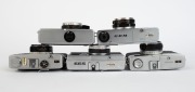 OLYMPUS: Five c. 1967 chrome-body cameras - one Quickmatic 600 [#239381] with E. Zuiko 38mm f2.8 lens, one Quickmatic EES [#125385] with D. Zuiko 36mm f2.8 lens, one Quickmatic EEM [#202513] with D. Zuiko 36mm f2.8 lens, one Trip 35 [#1332885] with D. Zui - 4