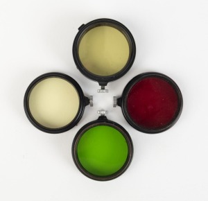 LEITZ: Five c. 1934 type B black slip-on lens filters - one FEOGG light red, one FIPOS green, and three FIHEL v. light yellow. (5 items)