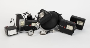 FRANKE & HEIDECKE: Eight flash accessories in black - two Rolleiflash with differing diameters plus one additional camera attachment element, one Strobomatic E 17C with power cable, one 121BC with sync cable, one 100 XL, one 128BC, and one E 19 BC. (8 items)