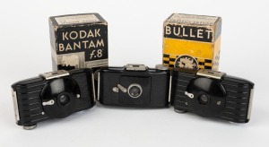 KODAK: Three black Bakelite cameras - one c. 1936 Bullet, one c. 1936 Bullet in maker's box, and one c. 1938 Bantam f.8. (3 cameras)