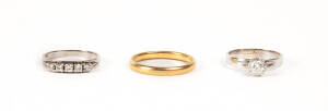 RINGS: 18ct white gold and diamond solitaire; 18ct white gold ring set with five diamonds; gold wedding band.