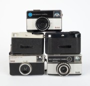 KODAK: Seven c. 1970s compact cameras - one Instamatic 25 in maker's box, one Instamatic 33, one Instamatic 56 X in maker's box with film roll/strap/flash cube, one Instamatic 133 with maker's box, one Instamatic 155 X, one Instamatic 233 X in maker's box - 2
